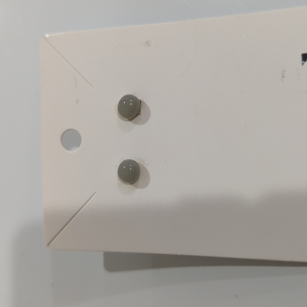 Artisan Handmade small grey opaque glass studs. .25m in size.